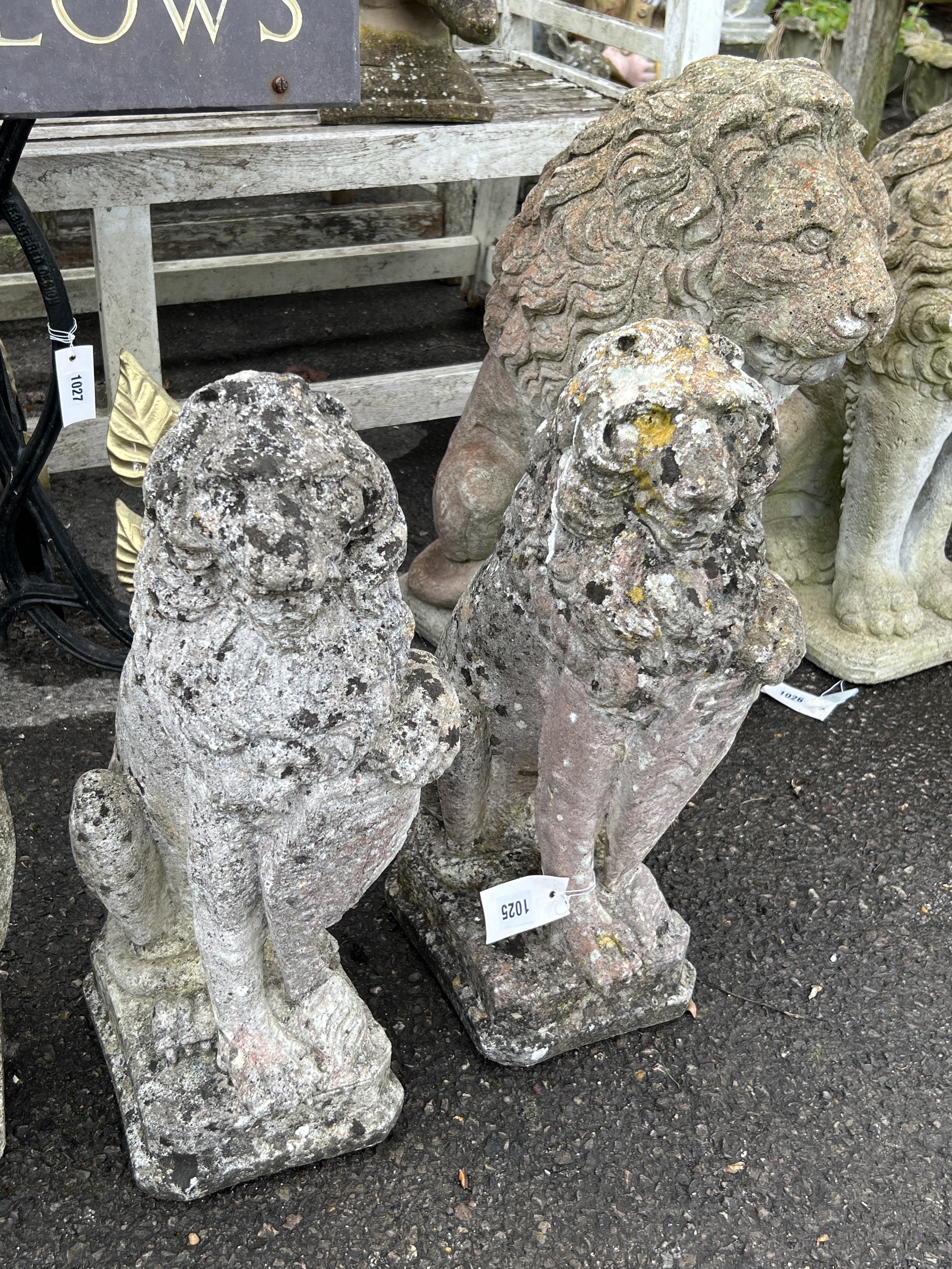 A pair of reconstituted stone heraldic lion garden ornaments, height 52cm